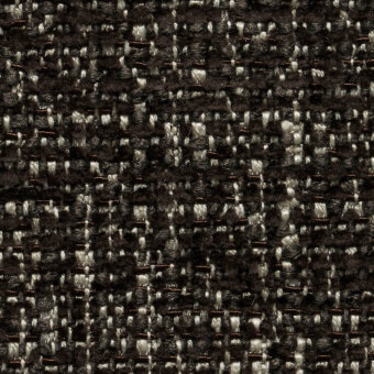 Woven tweed fabric, dark brown and off-white, dense irregular pattern with visible fibers and matte finish, labeled “lucinasco” textile.